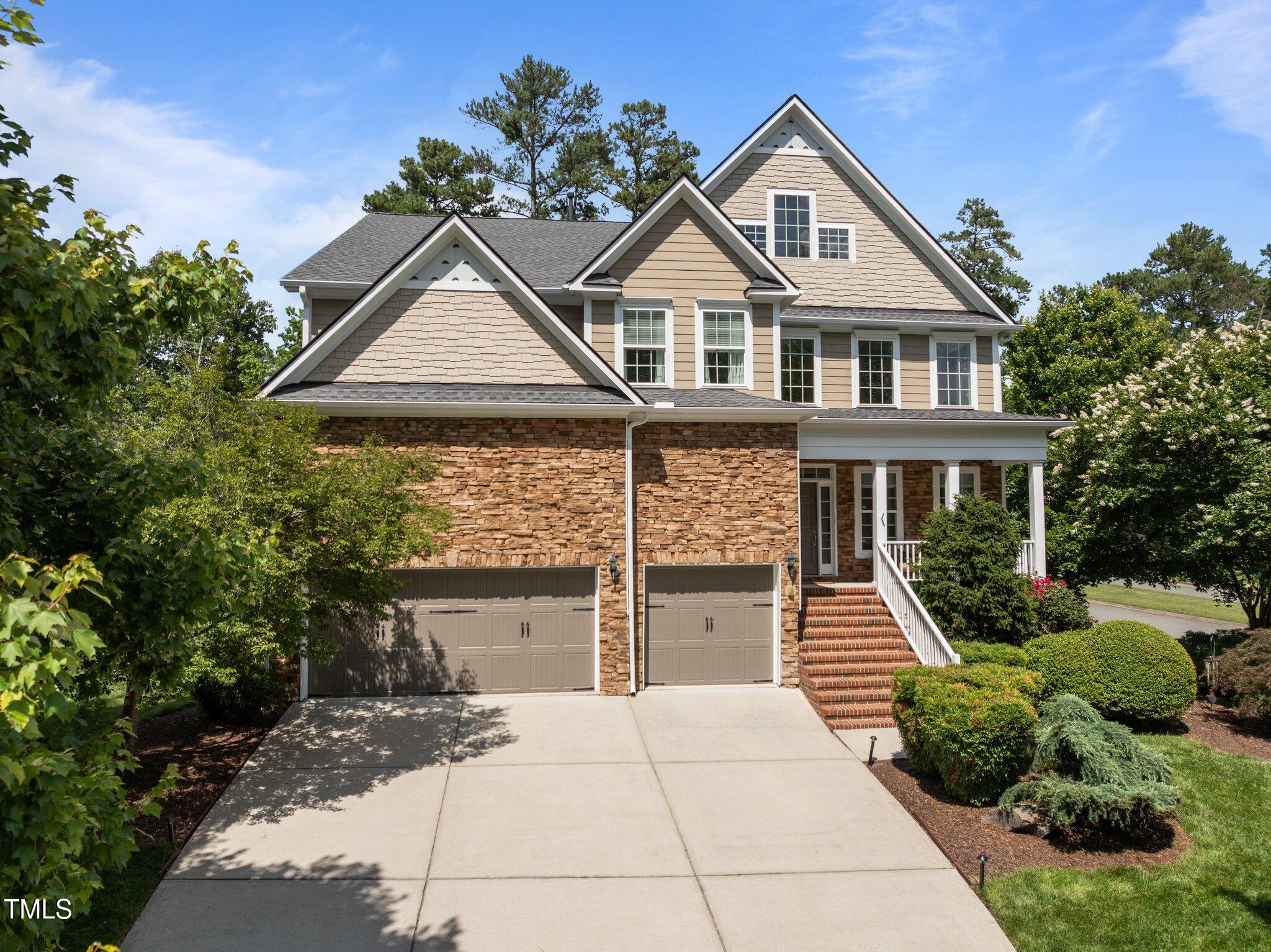 705 Harkness Circle Durham, NC 27705 - Photo 2 of 58 a front view of a house with a yard and garage