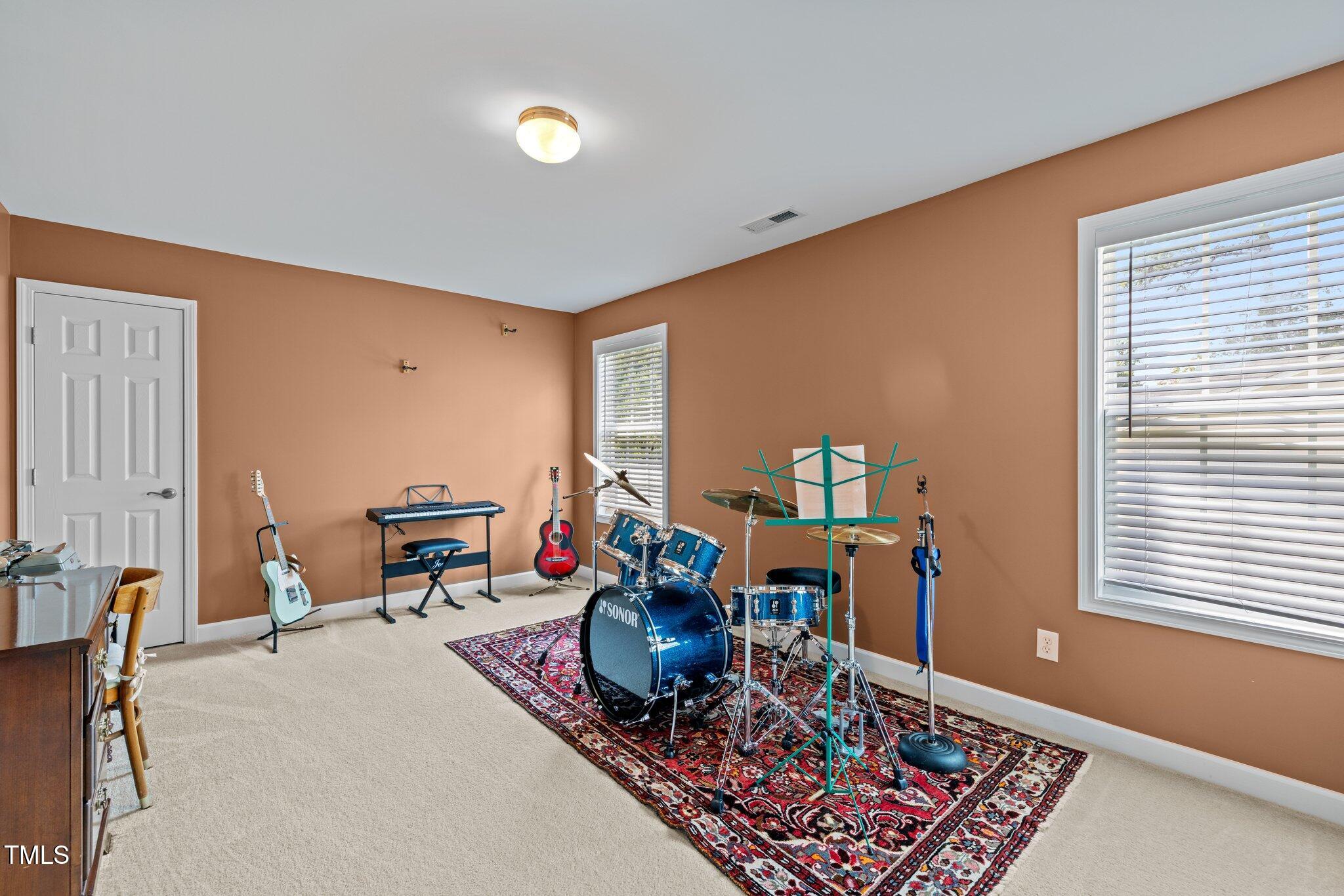 705 Harkness Circle Durham, NC 27705 - Photo 31 of 58 a work room with furniture a rug and a window