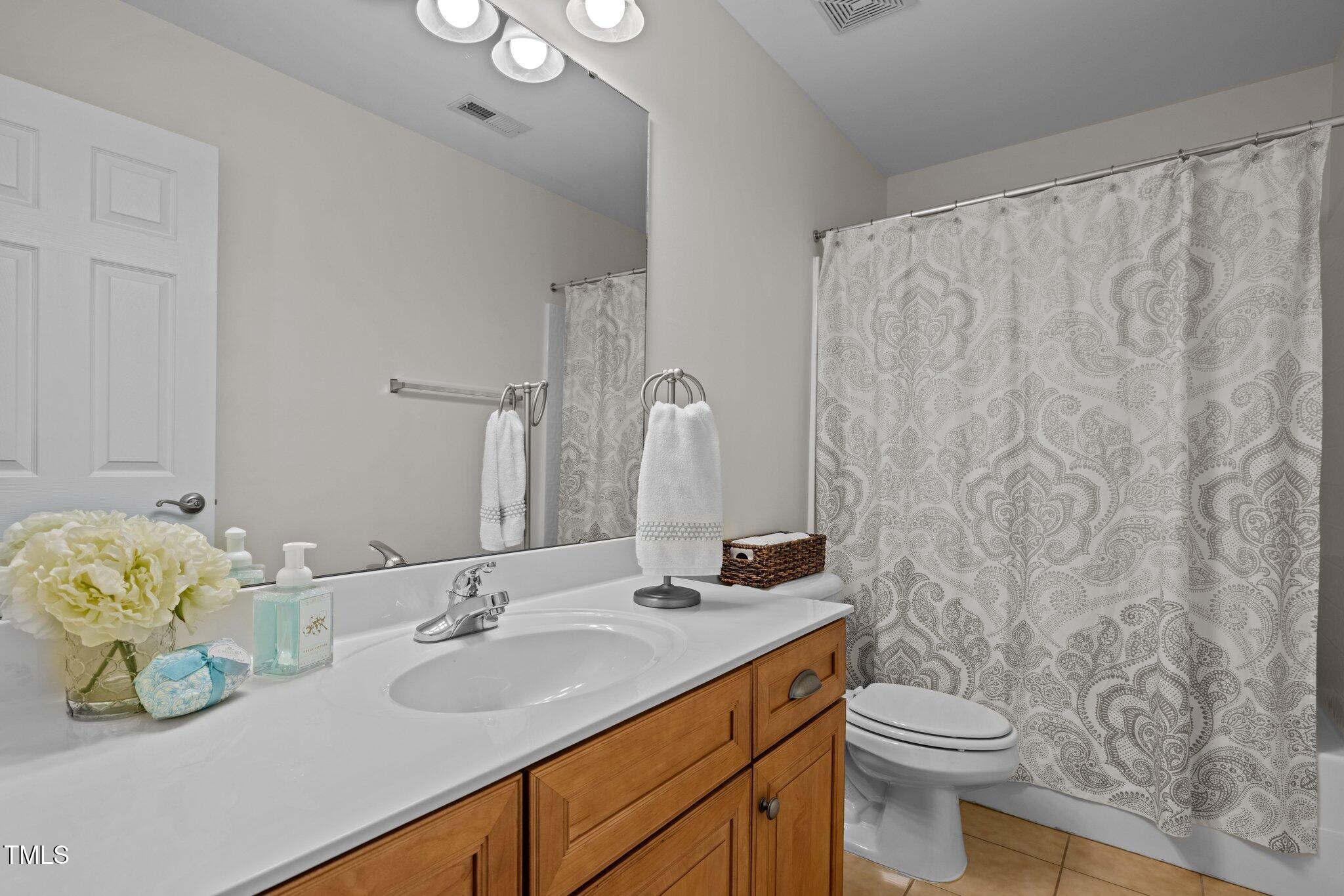 705 Harkness Circle Durham, NC 27705 - Photo 33 of 58 a bathroom with a sink a toilet and a mirror