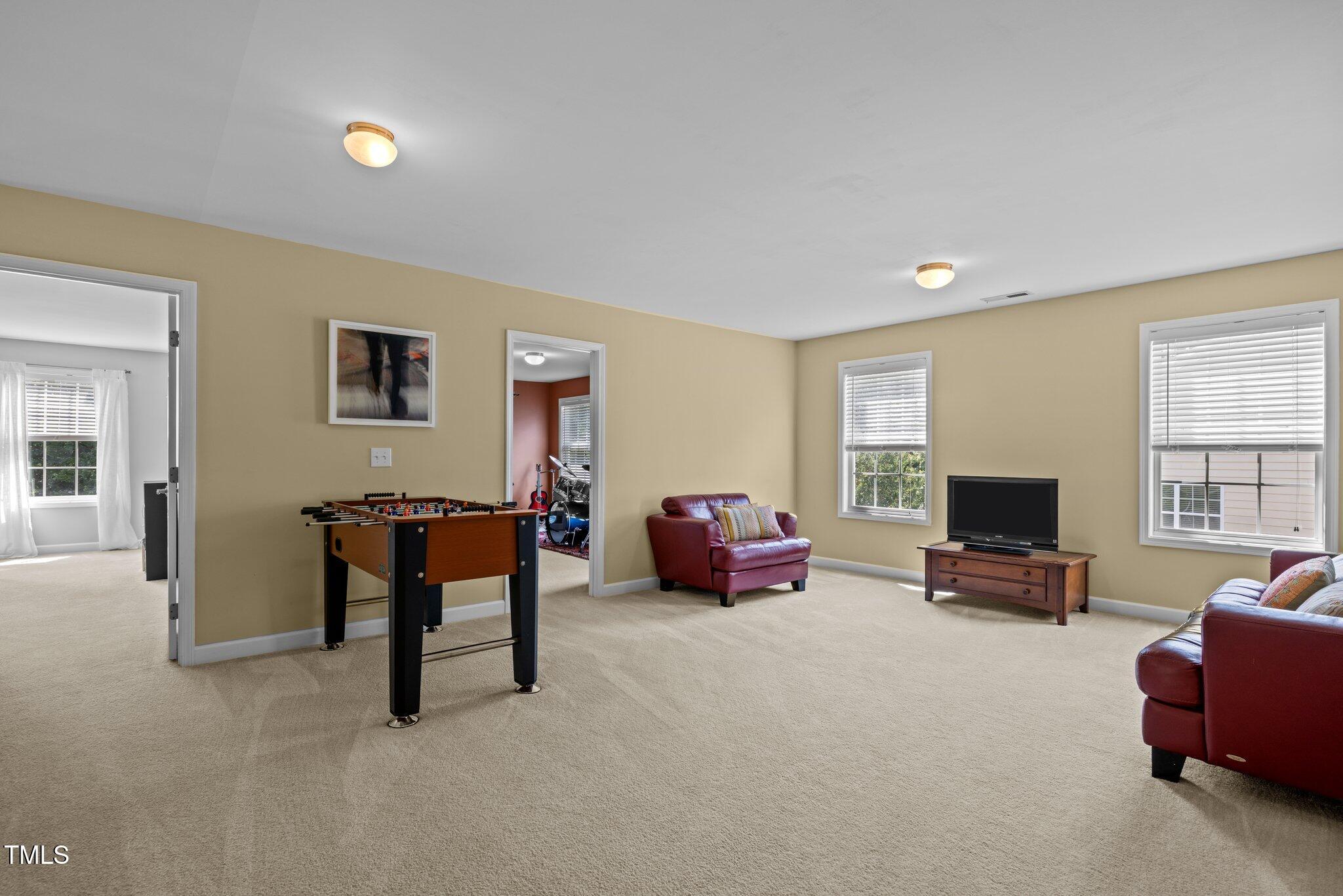 705 Harkness Circle Durham, NC 27705 - Photo 34 of 58 a living room with furniture and a flat screen tv