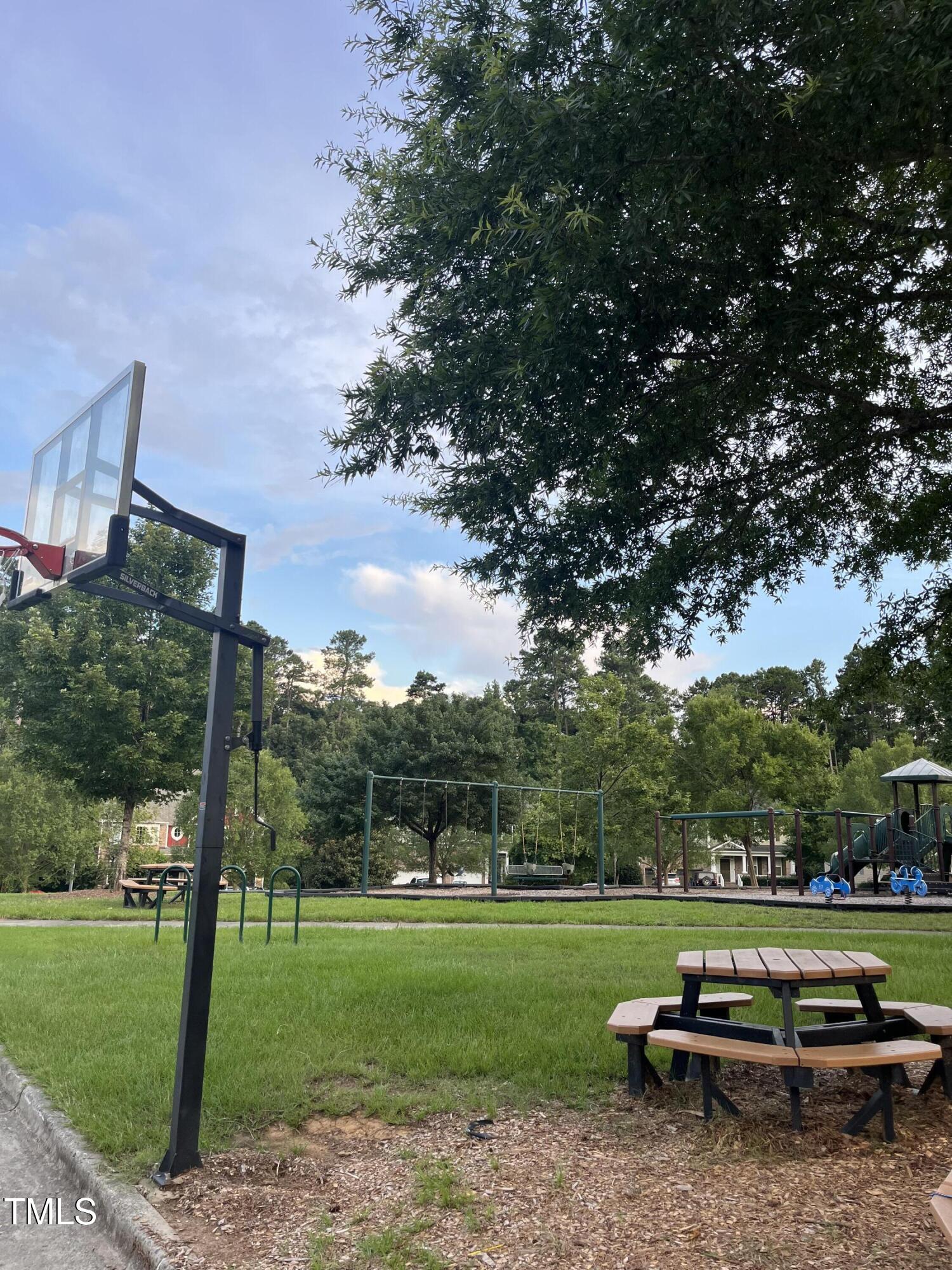 705 Harkness Circle Durham, NC 27705 - Photo 51 of 58 a bench is sitting in the grass near a yard