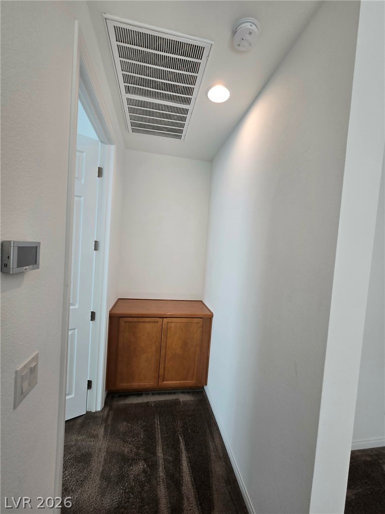 4748 Ritual Street North Las Vegas, NV 89031 - Photo 17 of 31 An inviting hallway with plush carpeting and a convenient built-in cabinet for storage.