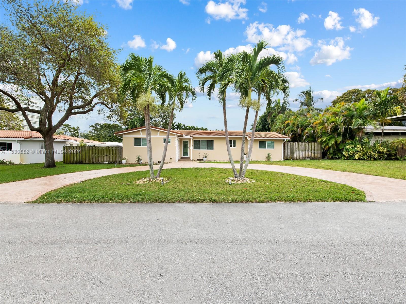 3444 Pierce Street Hollywood, FL 33021 - Photo 1 of 27 a front view of a house with a yard and garage