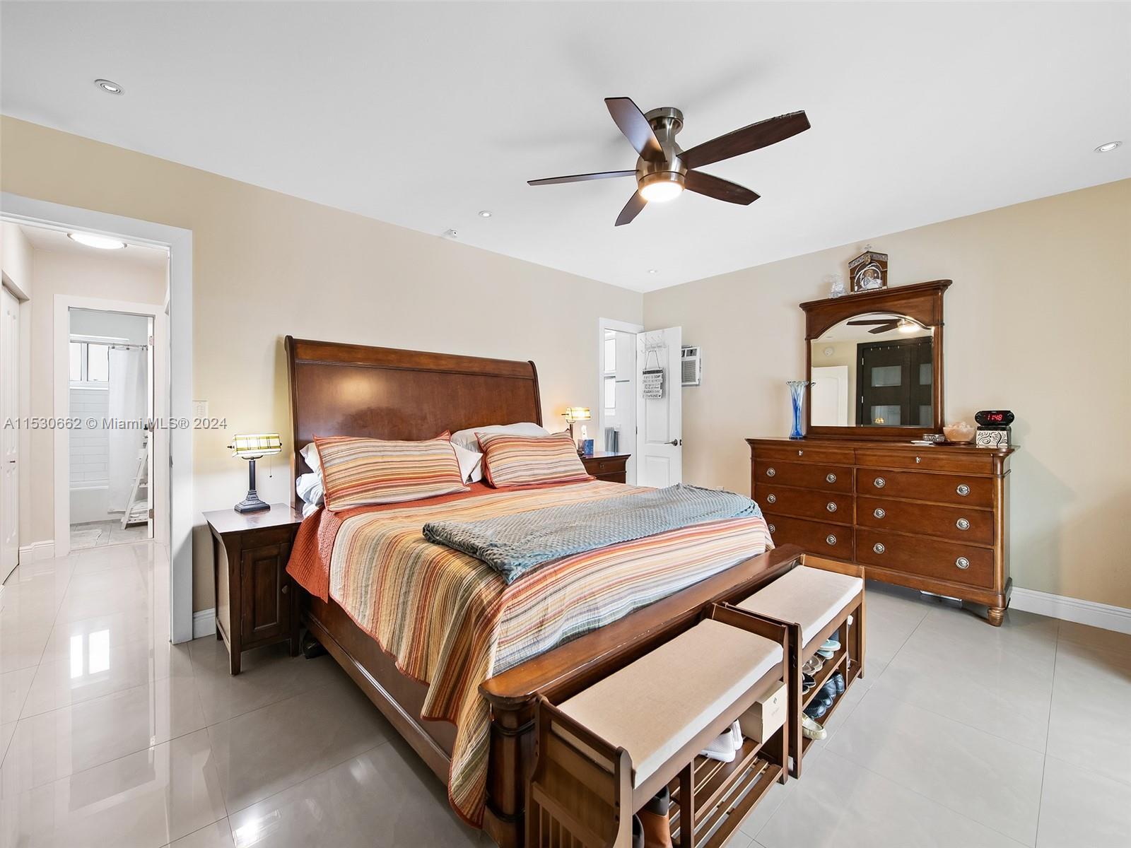 3444 Pierce Street Hollywood, FL 33021 - Photo 15 of 27 a bedroom with a bed and wooden floor