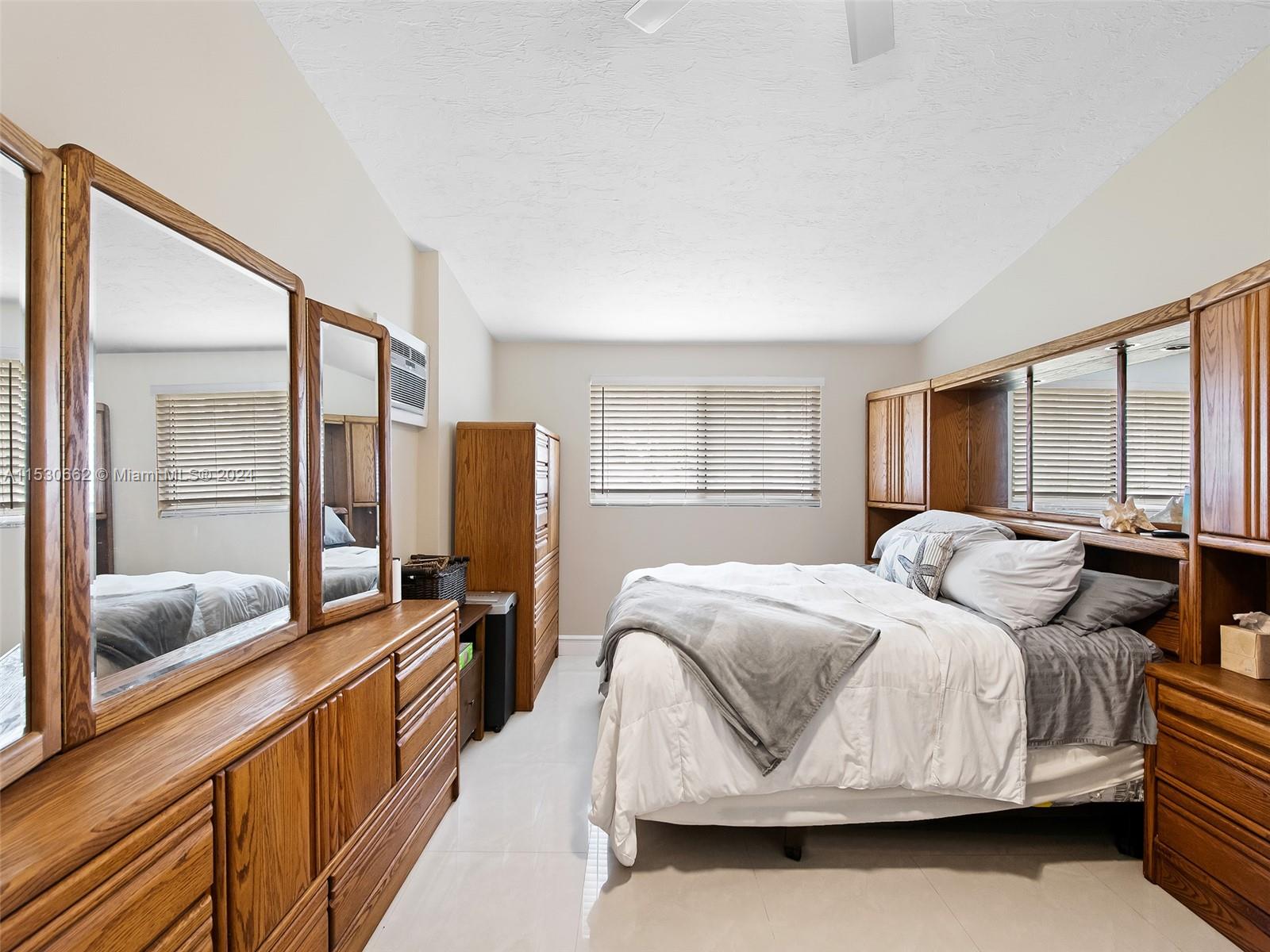 3444 Pierce Street Hollywood, FL 33021 - Photo 18 of 27 a bedroom with a bed and wooden floor