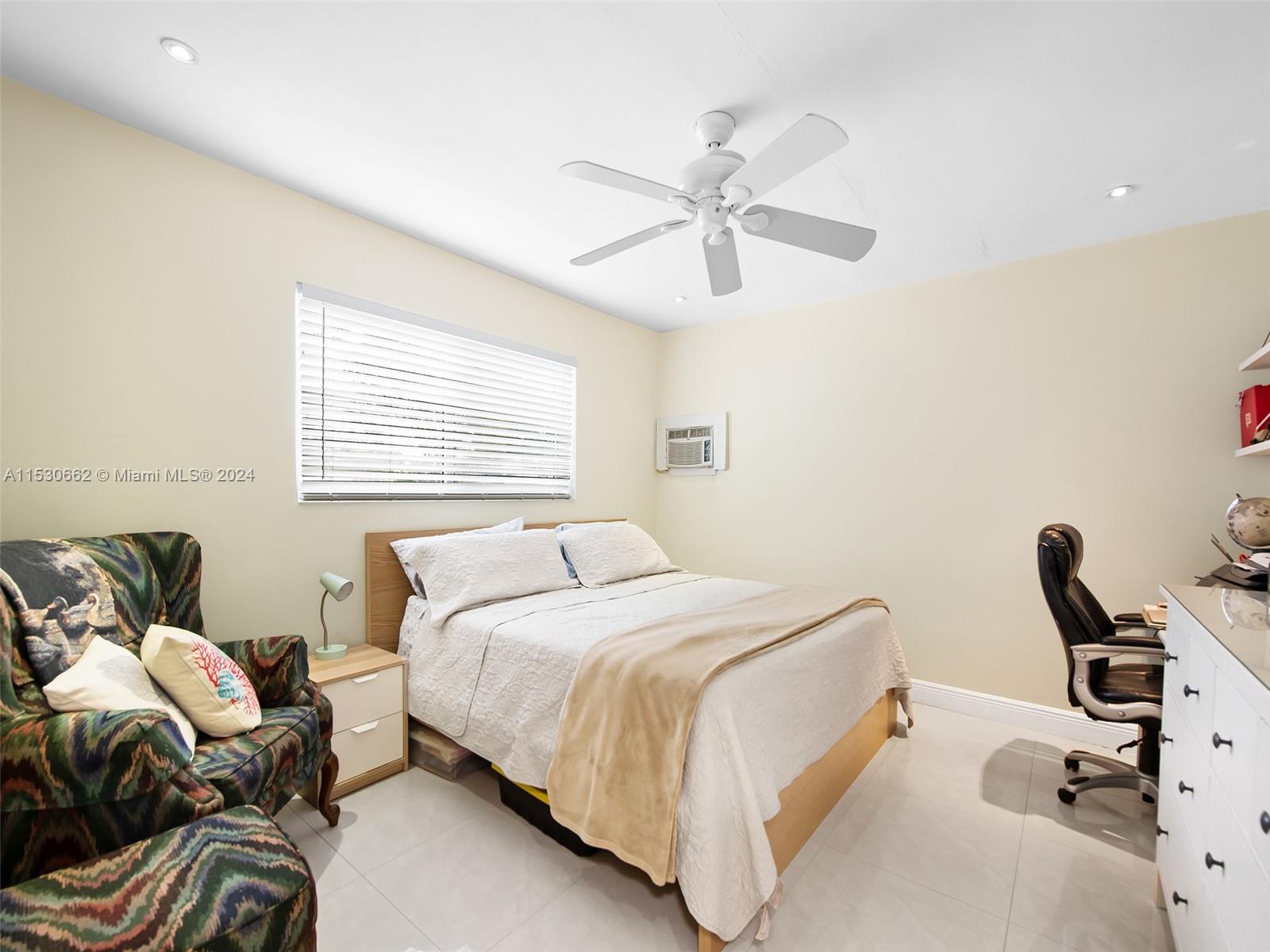 3444 Pierce Street Hollywood, FL 33021 - Photo 19 of 27 a bedroom with a bed and a chandelier