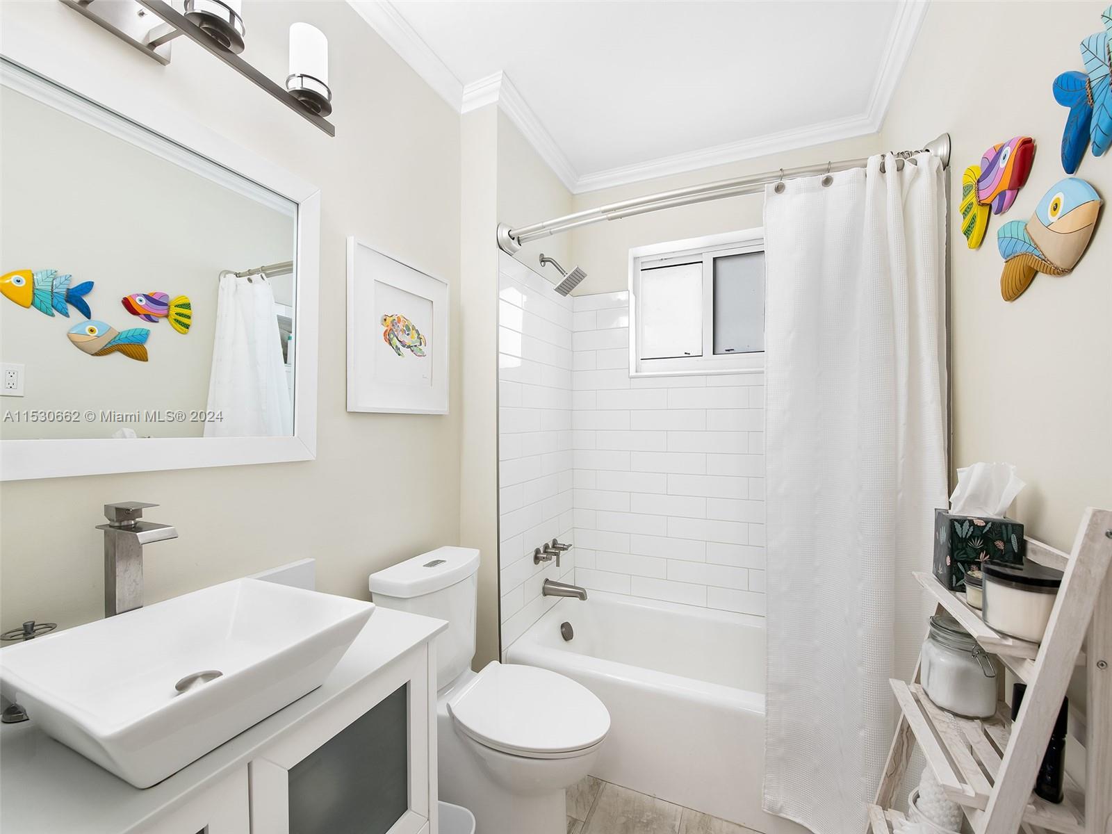 3444 Pierce Street Hollywood, FL 33021 - Photo 20 of 27 a bathroom with a sink a toilet and a shower curtain