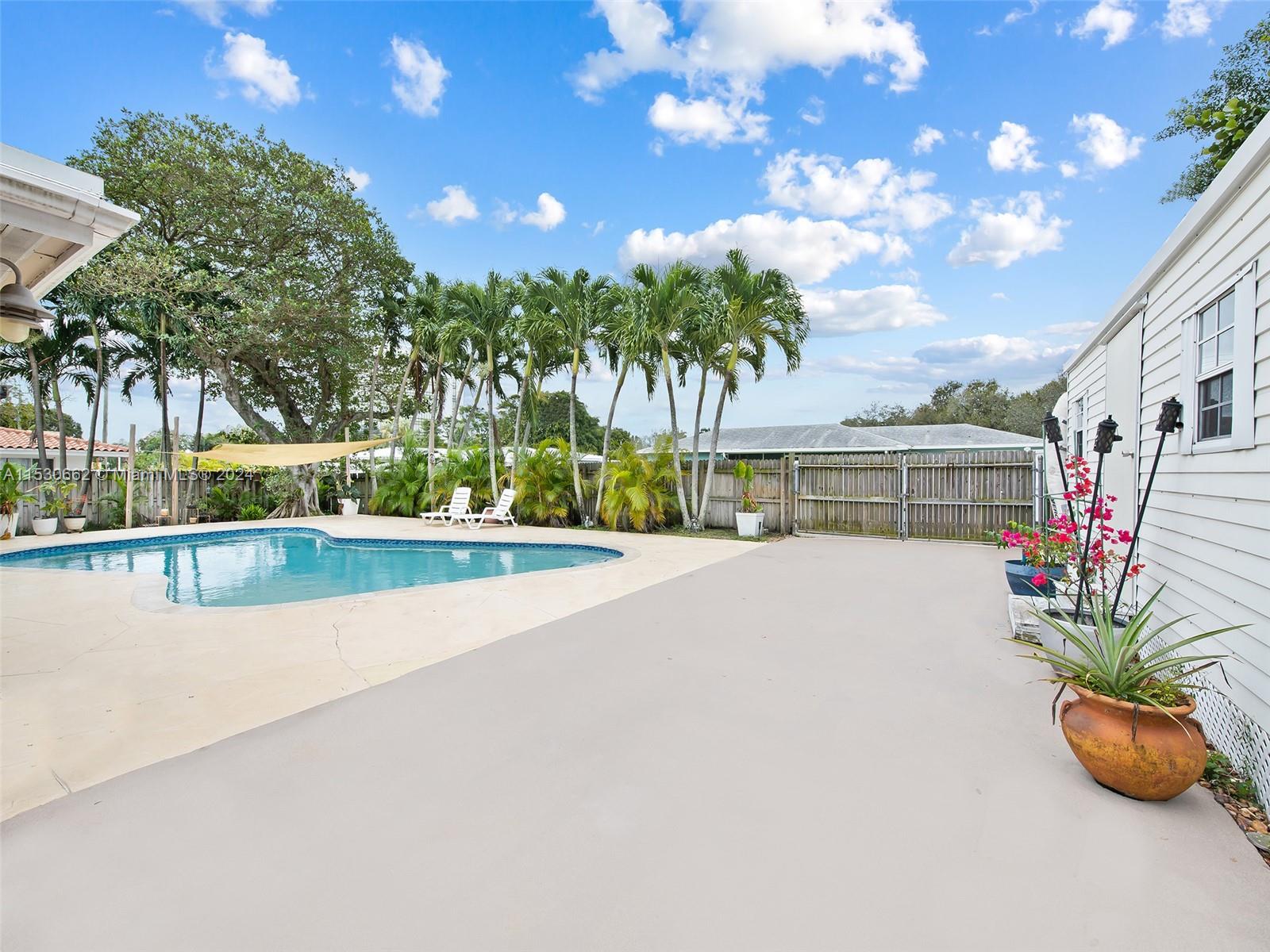 3444 Pierce Street Hollywood, FL 33021 - Photo 26 of 27 a view of swimming pool with a yard and potted plants