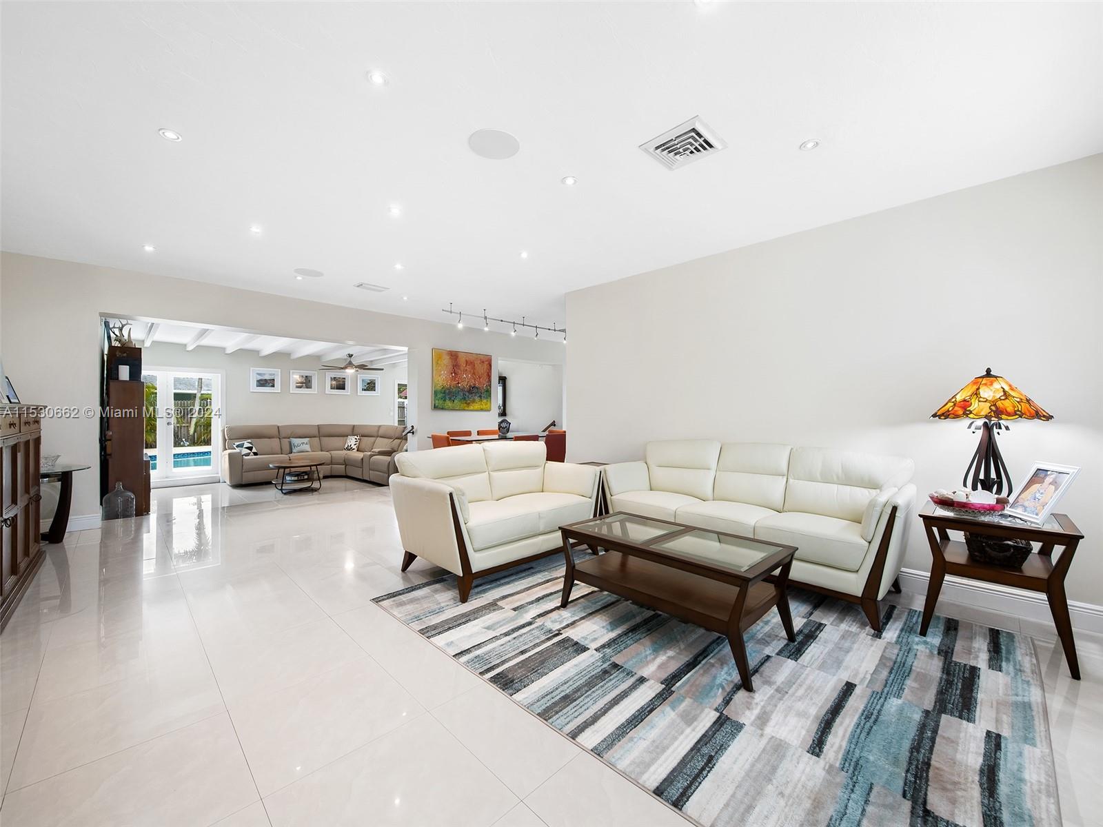 3444 Pierce Street Hollywood, FL 33021 - Photo 5 of 27 a living room with furniture and a table