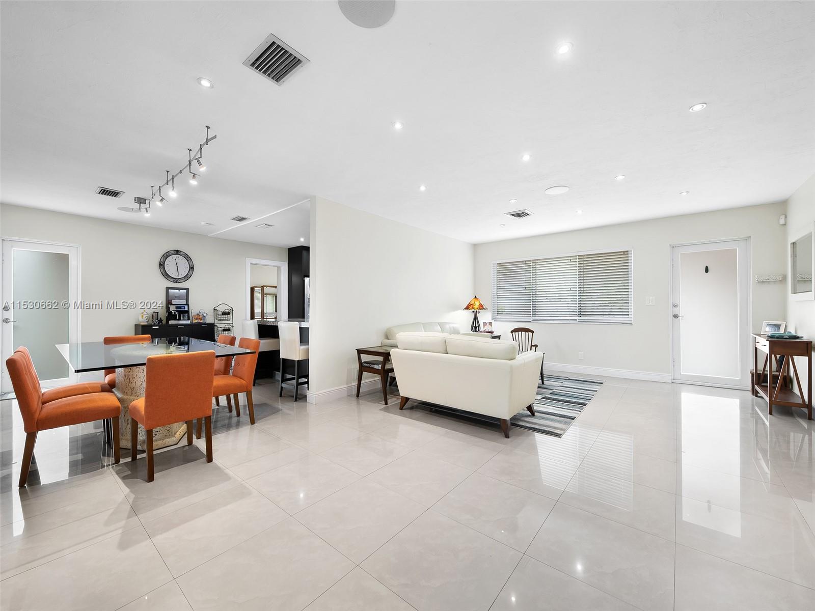 3444 Pierce Street Hollywood, FL 33021 - Photo 6 of 27 a living room with furniture and a chandelier