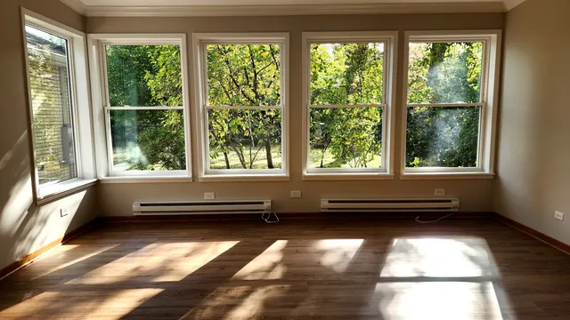 a view of room with windows and furniture