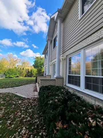a view of a house with backyard and garden