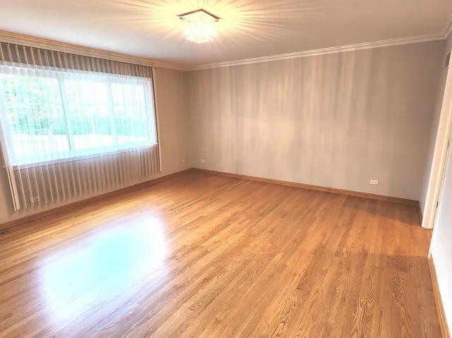 a view of a room with wooden floor and a window