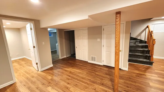 a view of a room with wooden floor and stairs