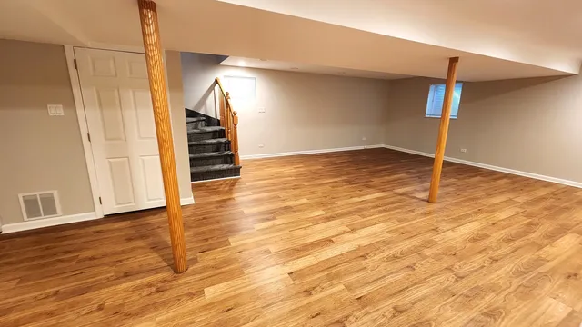 a view of an empty room with wooden floor