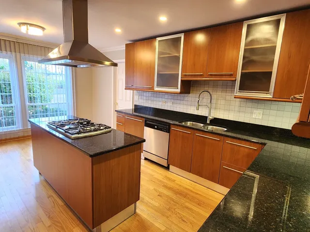 a kitchen with stainless steel appliances granite countertop a sink stove and refrigerator