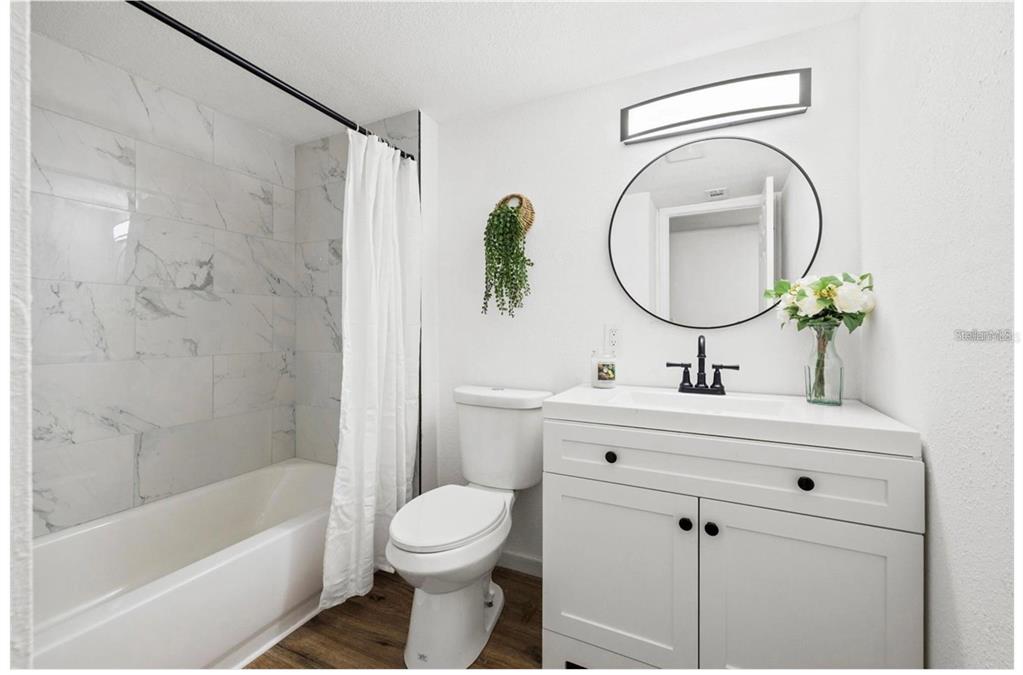 508 Brooker Road Brandon, FL 33511 - Photo 11 of 18 a bathroom with a sink a toilet and a mirror