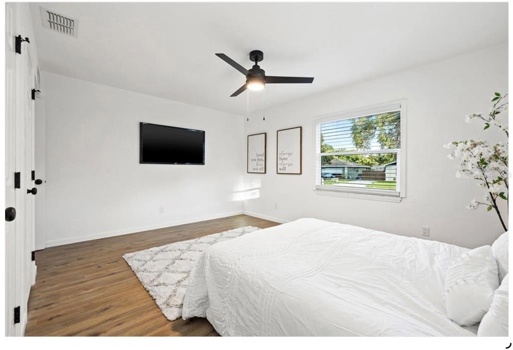 508 Brooker Road Brandon, FL 33511 - Photo 13 of 18 a bedroom with a large bed and a flat screen tv