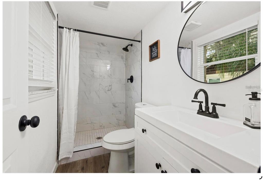 508 Brooker Road Brandon, FL 33511 - Photo 14 of 18 a bathroom with a sink a toilet and a mirror