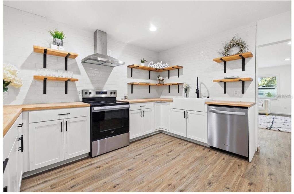 508 Brooker Road Brandon, FL 33511 - Photo 6 of 18 a kitchen with a stove cabinets and wooden floor