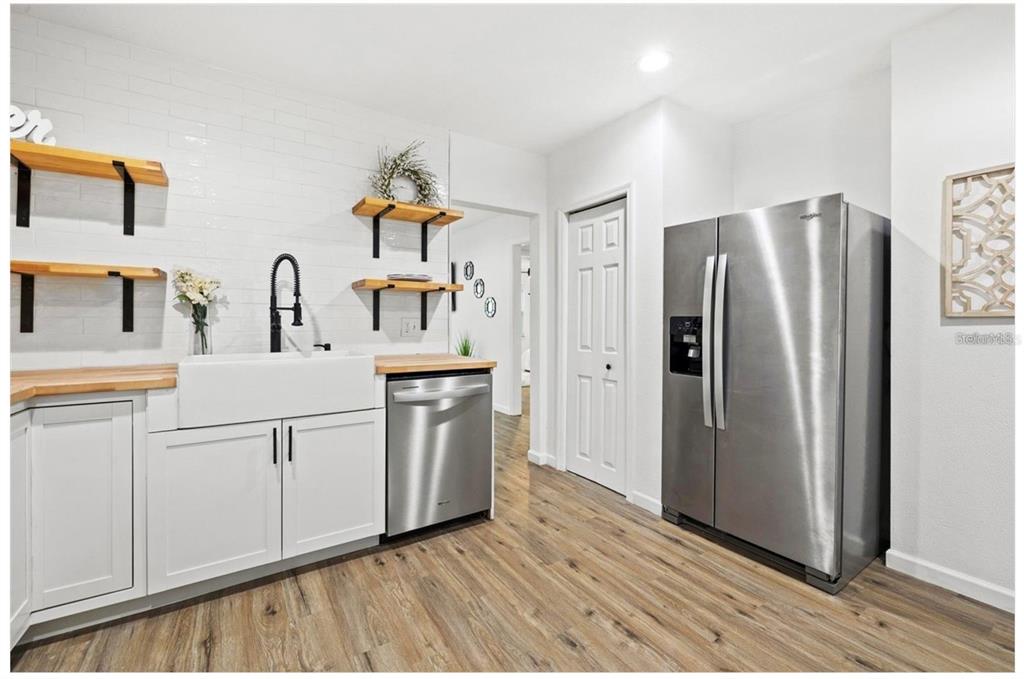 508 Brooker Road Brandon, FL 33511 - Photo 7 of 18 a kitchen with white cabinets and stainless steel appliances