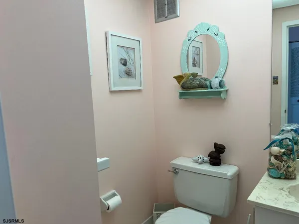 a bathroom with a sink toilet and mirror