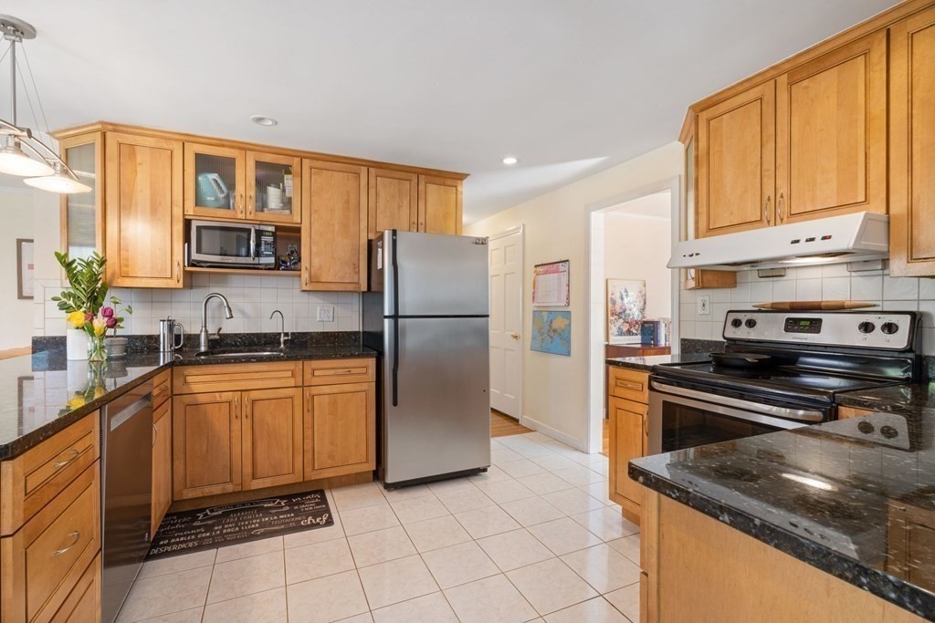 265 Riverside Drive Dedham, MA 02026 - Photo 11 of 41 a kitchen with stainless steel appliances granite countertop a refrigerator stove top oven and sink
