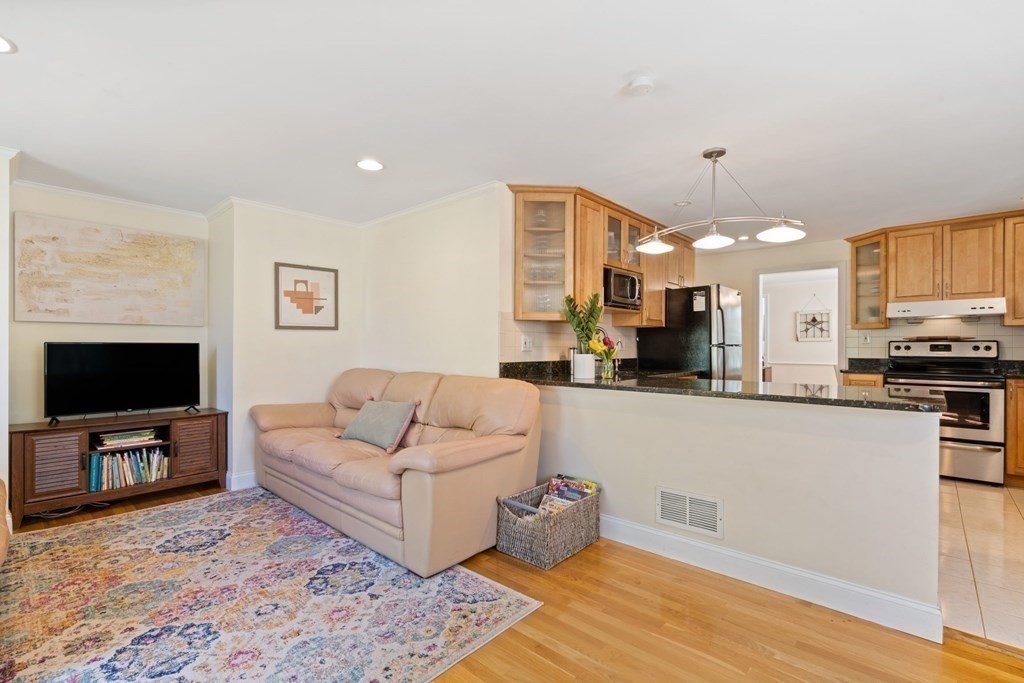 265 Riverside Drive Dedham, MA 02026 - Photo 18 of 41 a living room with stainless steel appliances furniture and a flat screen tv