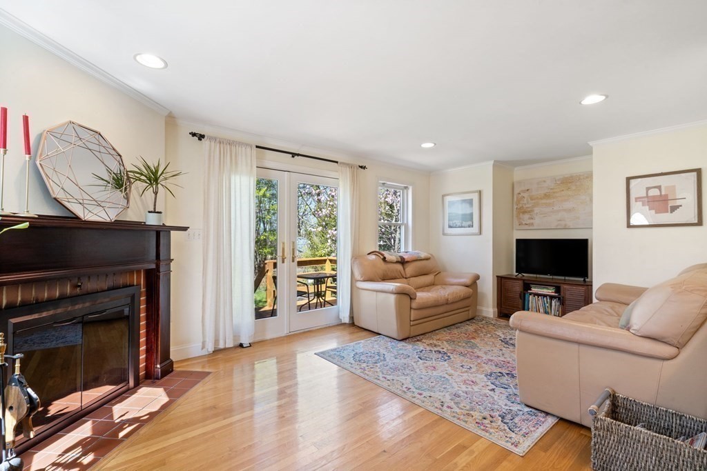 265 Riverside Drive Dedham, MA 02026 - Photo 20 of 41 a living room with furniture a fireplace and a flat screen tv
