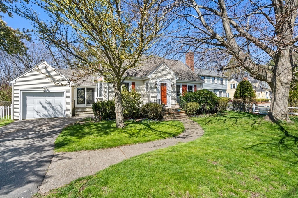 265 Riverside Drive Dedham, MA 02026 - Photo 2 of 41 a front view of a house with a yard and trees