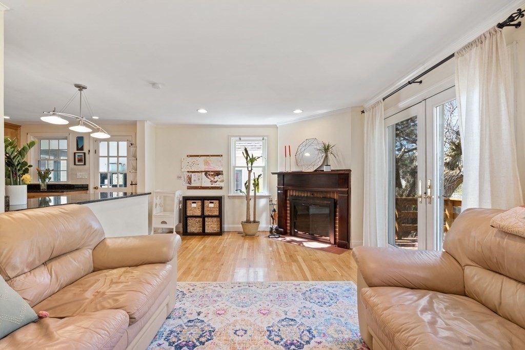 265 Riverside Drive Dedham, MA 02026 - Photo 21 of 41 a living room with furniture a fireplace and a flat screen tv