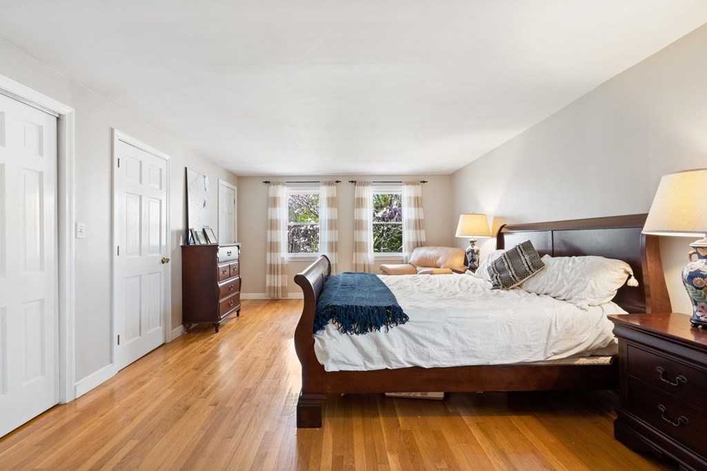 265 Riverside Drive Dedham, MA 02026 - Photo 24 of 41 a bedroom with a bed and wooden floor