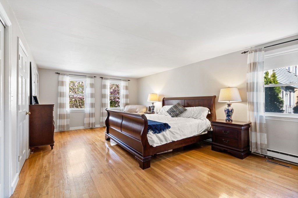 265 Riverside Drive Dedham, MA 02026 - Photo 25 of 41 a bedroom with a bed and wooden floor