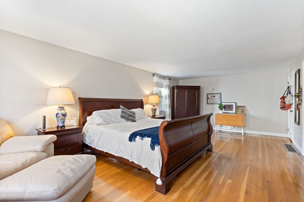 265 Riverside Drive Dedham, MA 02026 - Photo 26 of 41 a bedroom with a bed and lamp on desk