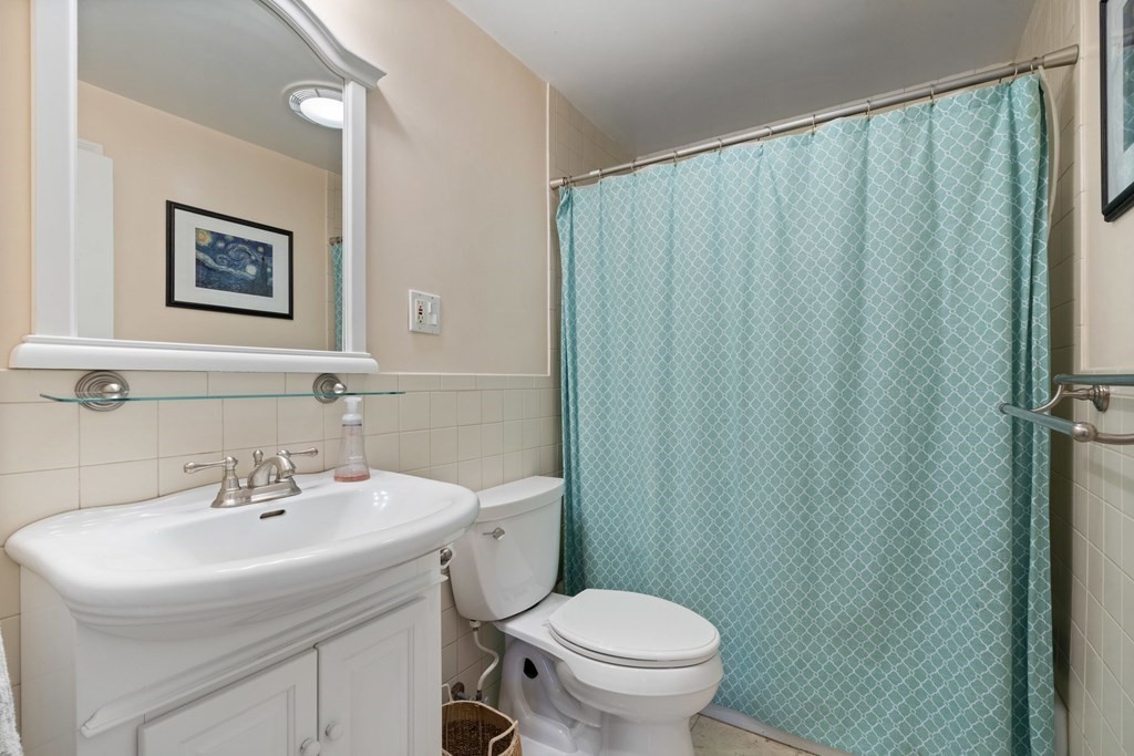265 Riverside Drive Dedham, MA 02026 - Photo 27 of 41 a bathroom with a sink toilet and a mirror