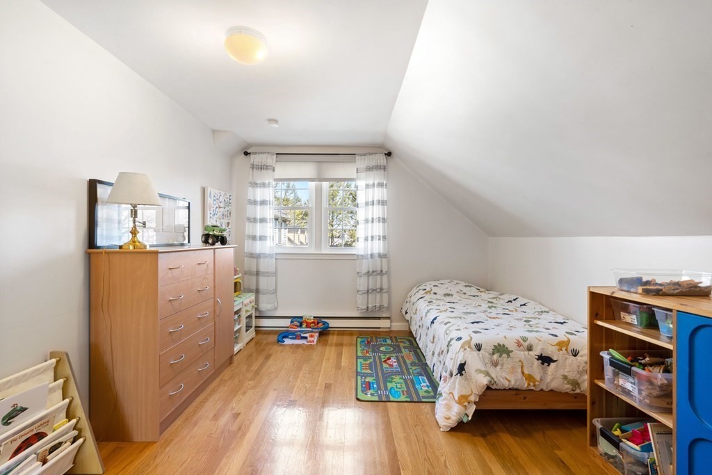265 Riverside Drive Dedham, MA 02026 - Photo 31 of 41 a bedroom with a bed and a book shelf