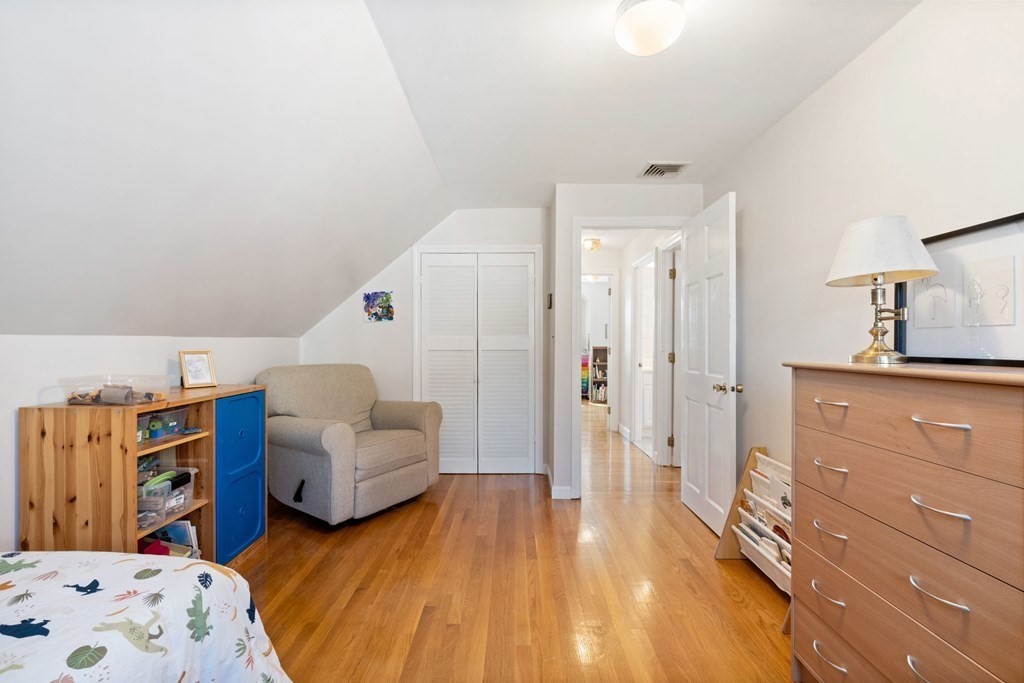 265 Riverside Drive Dedham, MA 02026 - Photo 32 of 41 a bedroom with furniture and a wooden floor