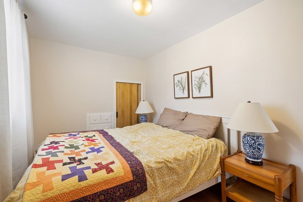 265 Riverside Drive Dedham, MA 02026 - Photo 33 of 41 a bedroom with a bed and painting on the wall