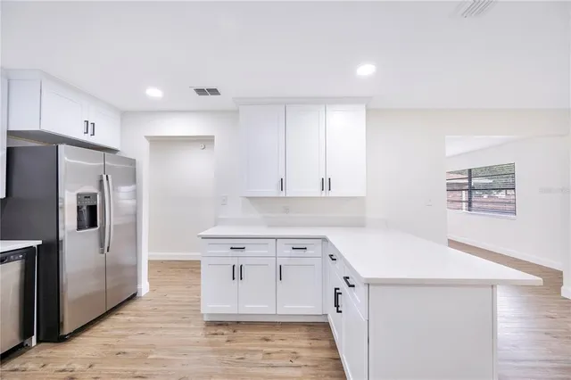 a kitchen with a sink appliances and cabinets