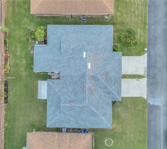 an aerial view of a house with a yard
