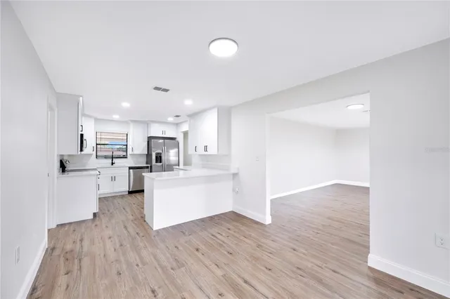 a view of kitchen with wooden floor