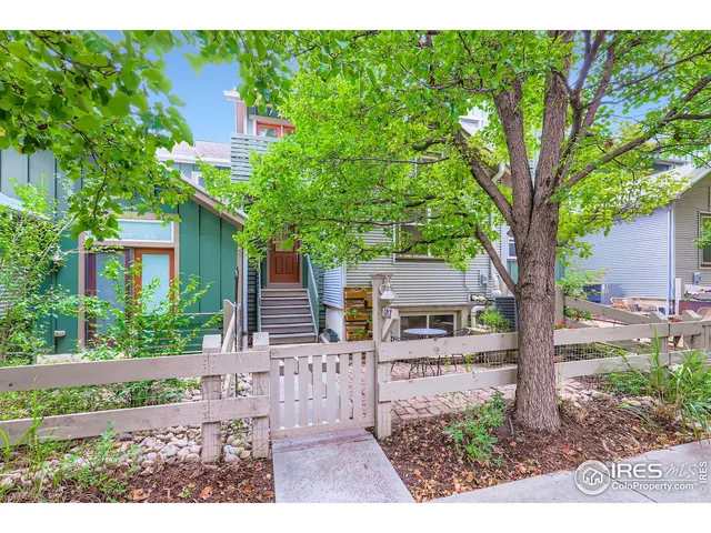 a view of a house with a tree in the background