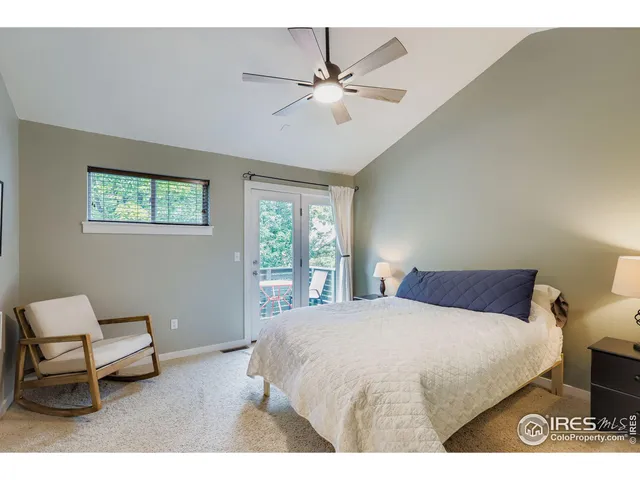 a bedroom with a bed a couch and a window