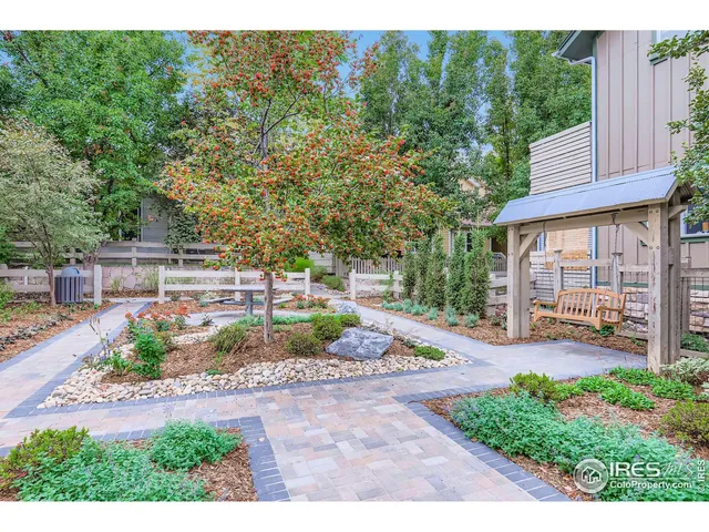 a view of a backyard with plants and patio