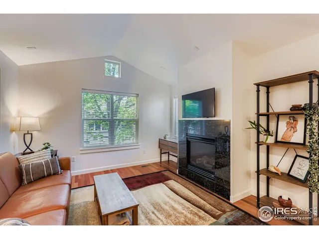 a living room with furniture fireplace and flat screen tv