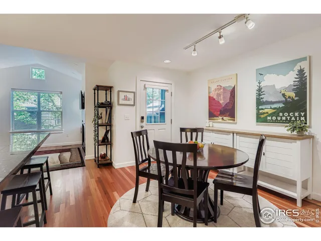 a dining room with furniture and wooden floor