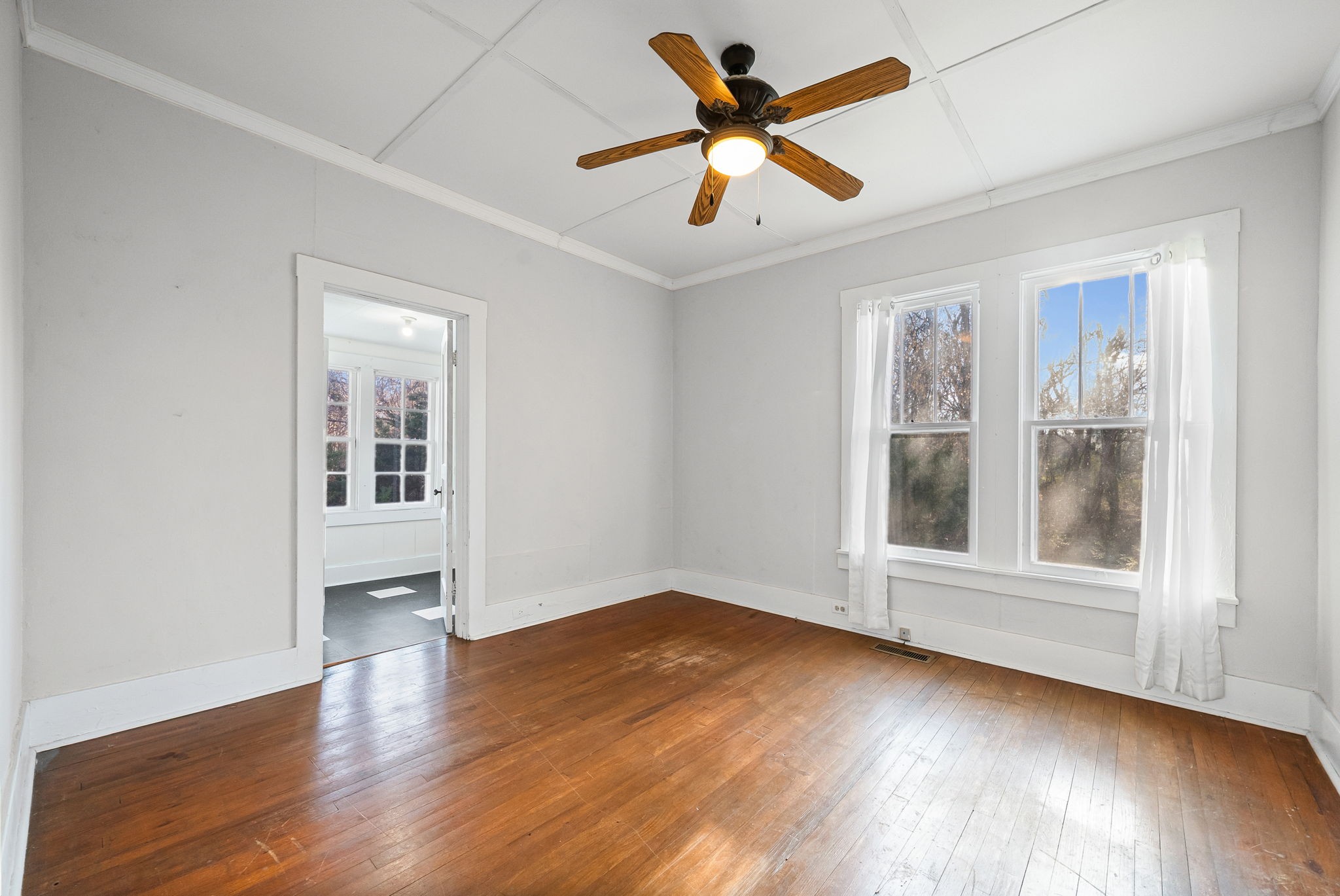 106 Cedar Street Dover, TN 37058 - Photo 11 of 32 an empty room with wooden floor and windows