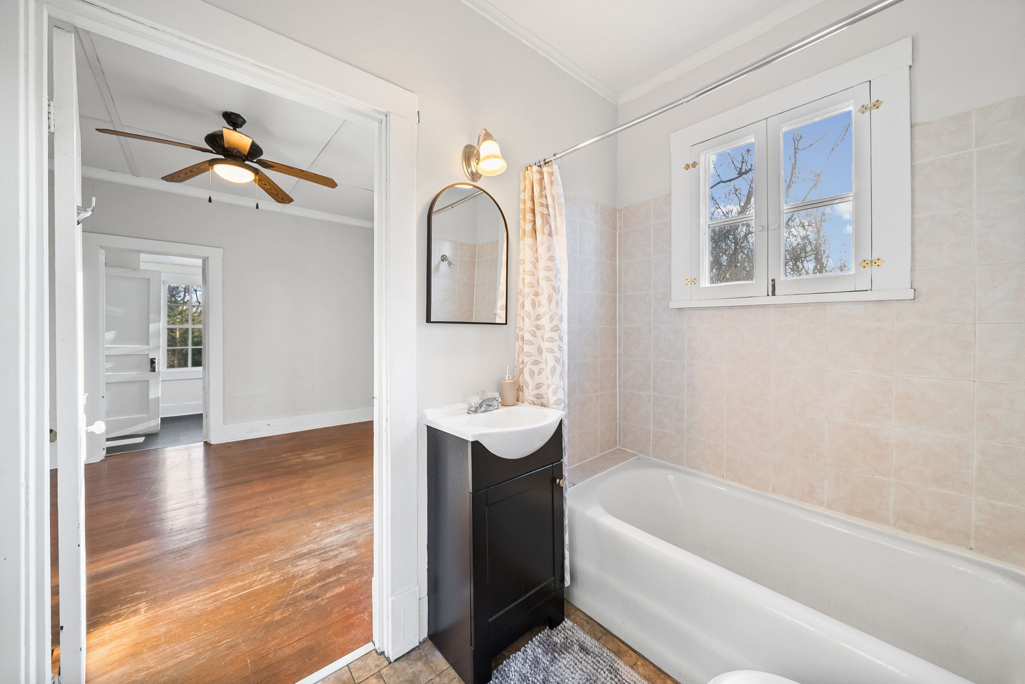 106 Cedar Street Dover, TN 37058 - Photo 14 of 32 a bathroom with a tub a sink and a chandelier