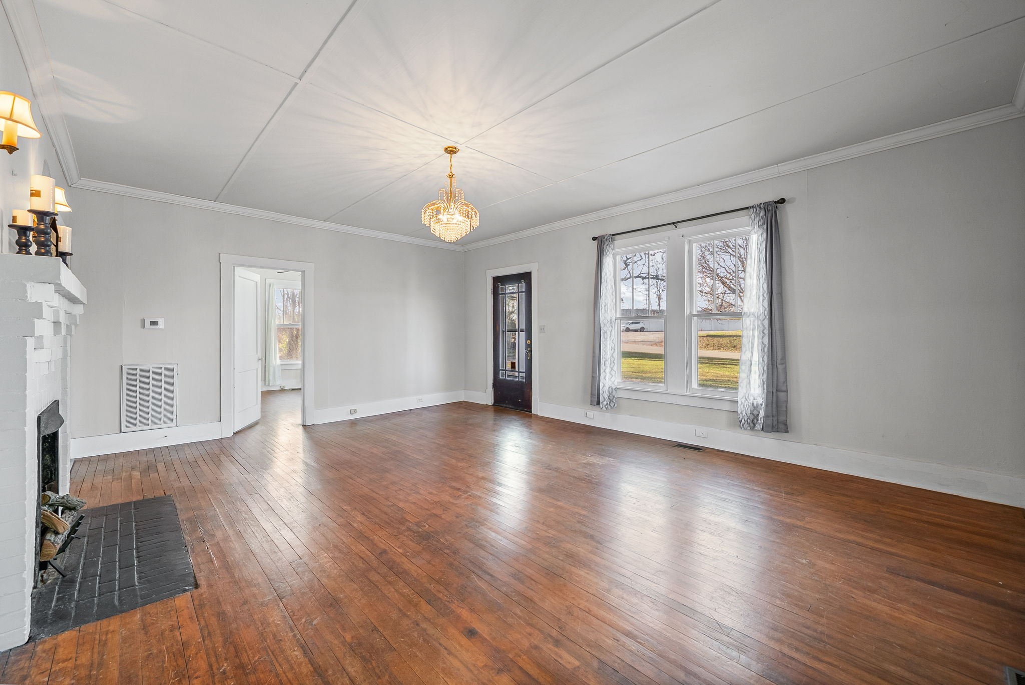 106 Cedar Street Dover, TN 37058 - Photo 3 of 32 a view of an empty room with wooden floor and a window