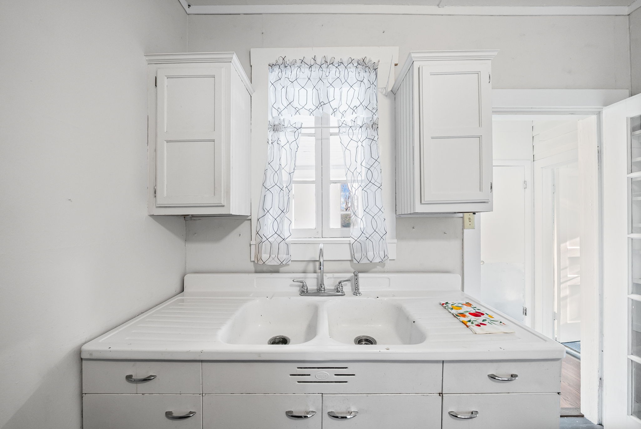 106 Cedar Street Dover, TN 37058 - Photo 6 of 32 a bathroom with a sink window and cabinets